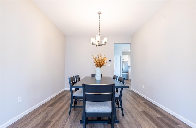1051 Miremont Dr, Manchester, MO 63011 - dining area with a chandelier, dark wood-style floors, and baseboards