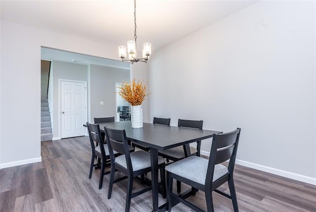 1051 Miremont Dr, Manchester, MO 63011 - dining room with a chandelier, wood finished floors, and baseboards