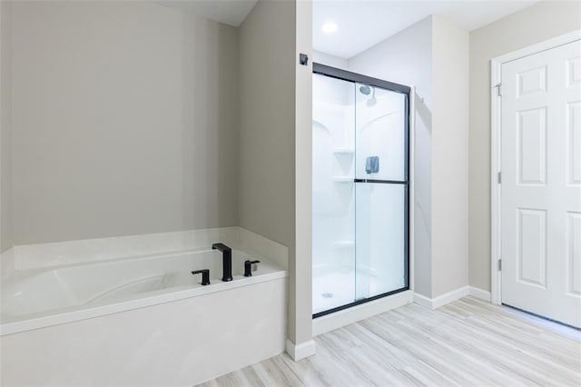 1051 Miremont Dr, Manchester, MO 63011 - full bathroom with a shower stall, a bath, baseboards, and wood finished floors