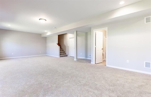 1051 Miremont Dr, Manchester, MO 63011 - empty room with stairs, light carpet, baseboards, and recessed lighting