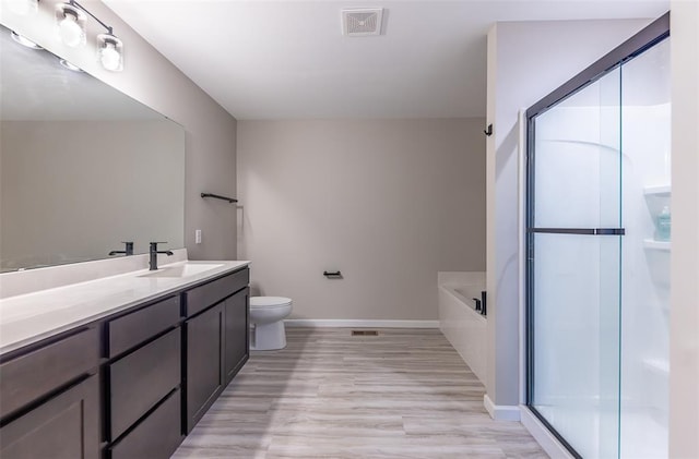 1051 Miremont Dr, Manchester, MO 63011 - full bathroom with vanity, baseboards, toilet, wood finished floors, and a shower stall