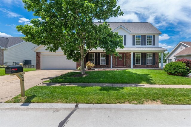 326 Merrimac Downs, Saint Peters, MO 63376 - traditional-style home with brick siding, concrete driveway, a front lawn, a garage, and covered porch
