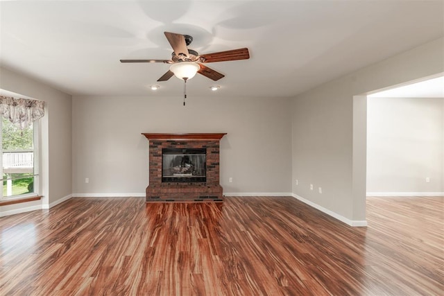 326 Merrimac Downs, Saint Peters, MO 63376 - unfurnished living room featuring ceiling fan, wood finished floors, a brick fireplace, and baseboards
