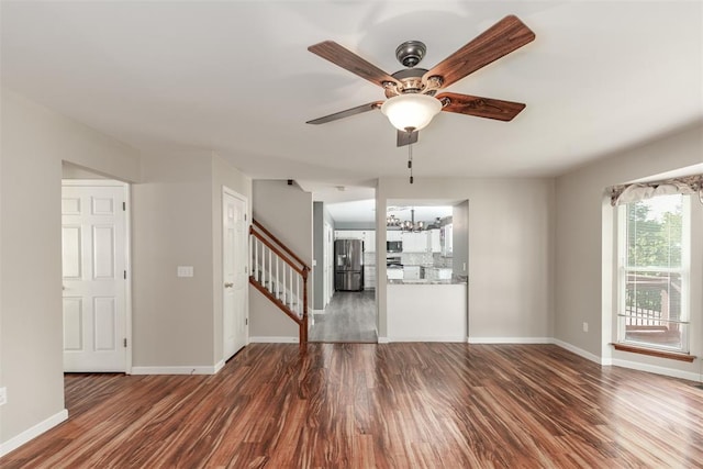 326 Merrimac Downs, Saint Peters, MO 63376 - unfurnished living room featuring ceiling fan, wood finished floors, stairway, baseboards, and a chandelier