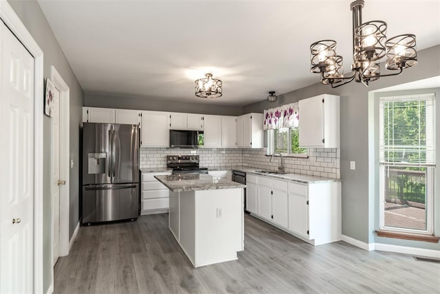 326 Merrimac Downs, Saint Peters, MO 63376 - kitchen with black appliances, a chandelier, a sink, and backsplash