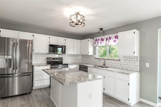 326 Merrimac Downs, Saint Peters, MO 63376 - kitchen featuring appliances with stainless steel finishes, a sink, light wood-type flooring, white cabinetry, and light stone counters