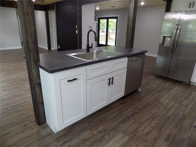 633 E Eldon St, St James, MO 65559 - kitchen with appliances with stainless steel finishes, a sink, dark countertops, and dark wood-style floors