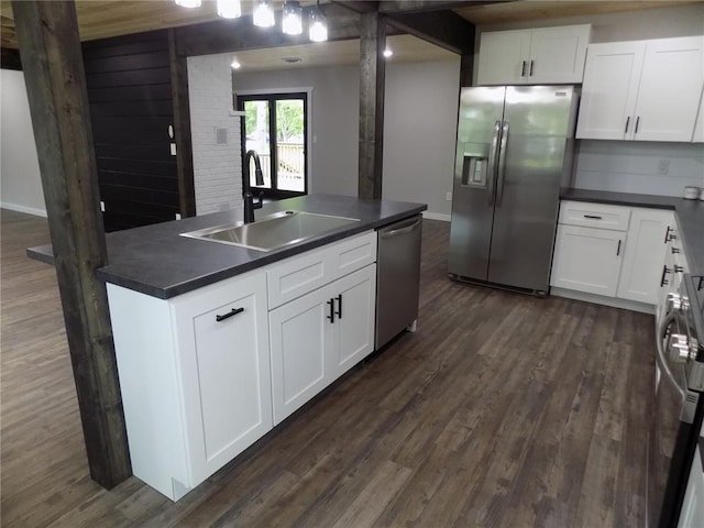 633 E Eldon St, St James, MO 65559 - kitchen featuring stainless steel appliances, a sink, dark countertops, and dark wood-type flooring