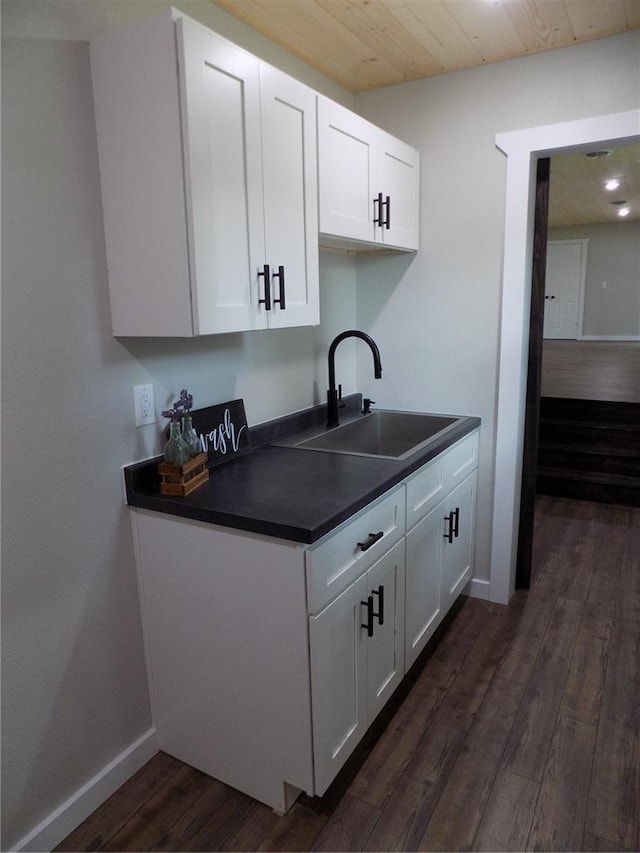 633 E Eldon St, St James, MO 65559 - kitchen featuring dark countertops, a sink, dark wood-style floors, white cabinets, and baseboards