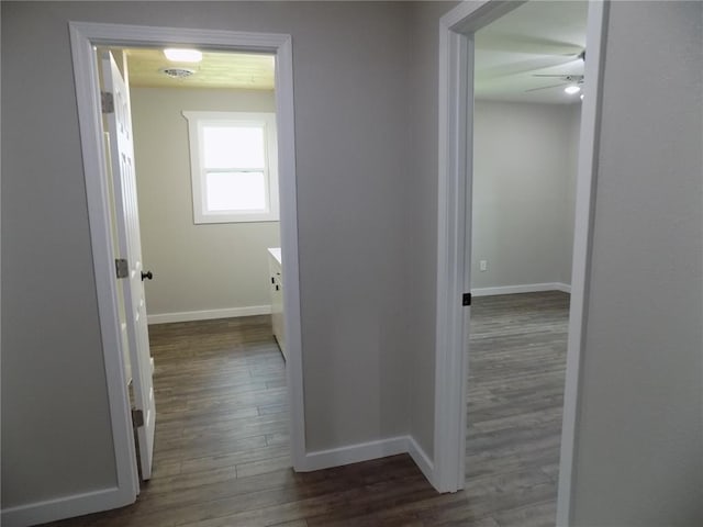 633 E Eldon St, St James, MO 65559 - hall featuring dark wood-style flooring and baseboards