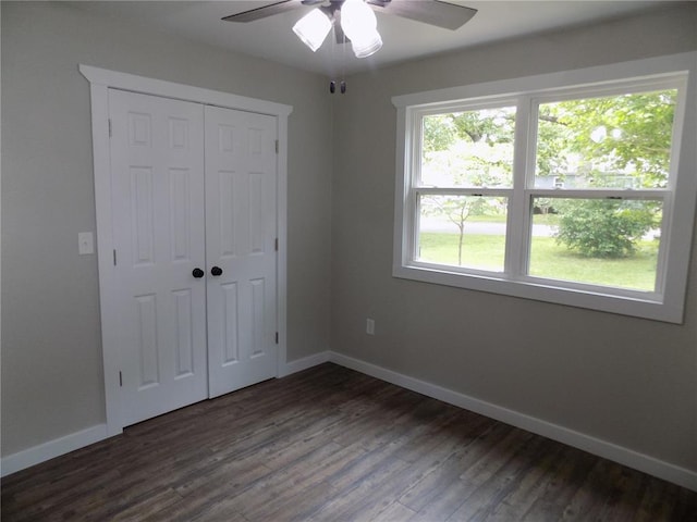 633 E Eldon St, St James, MO 65559 - unfurnished bedroom featuring baseboards, dark wood finished floors, a closet, and a ceiling fan