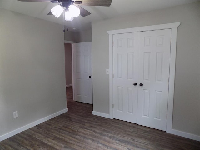 633 E Eldon St, St James, MO 65559 - unfurnished bedroom featuring a closet, baseboards, dark wood-style flooring, and a ceiling fan