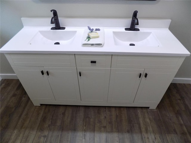 633 E Eldon St, St James, MO 65559 - bathroom view of double vanity, wood finished floors, and baseboards