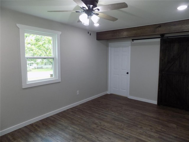 633 E Eldon St, St James, MO 65559 - unfurnished bedroom with dark wood-type flooring, baseboards, and a ceiling fan
