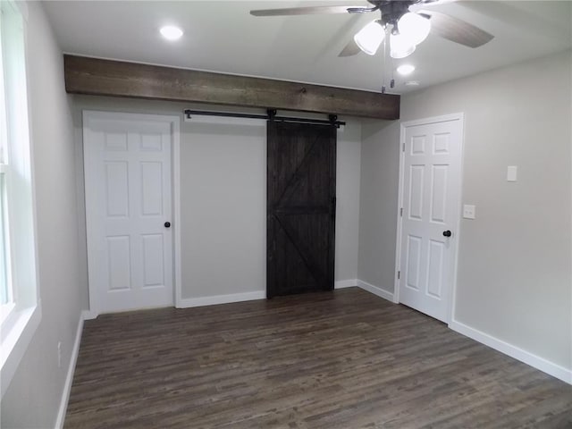 633 E Eldon St, St James, MO 65559 - unfurnished bedroom with dark wood-style flooring, baseboards, recessed lighting, ceiling fan, and a barn door