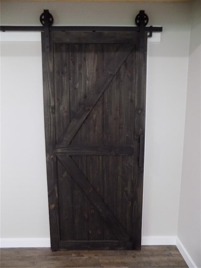 633 E Eldon St, St James, MO 65559 - detailed view of a barn door, baseboards, and wood finished floors