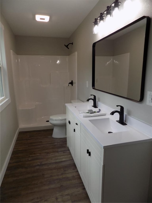 633 E Eldon St, St James, MO 65559 - bathroom featuring toilet, double vanity, wood finished floors, and a shower