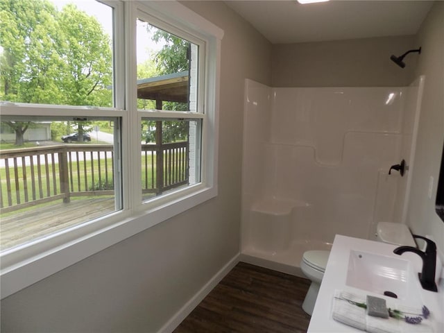 633 E Eldon St, St James, MO 65559 - full bathroom with a sink, baseboards, a shower, toilet, and wood finished floors