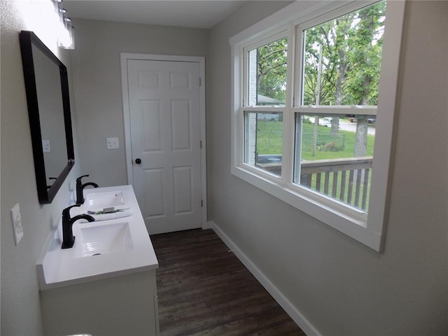 633 E Eldon St, St James, MO 65559 - bathroom featuring double vanity, baseboards, and wood finished floors