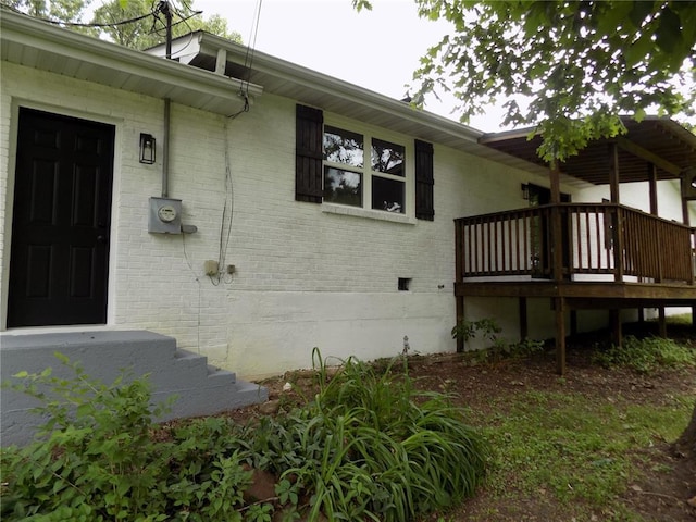 633 E Eldon St, St James, MO 65559 - view of property exterior with brick siding, a deck, and crawl space