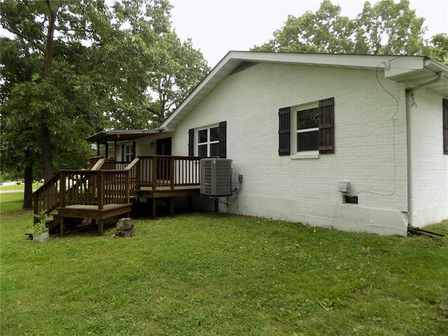 633 E Eldon St, St James, MO 65559 - rear view of house with a wooden deck, a yard, brick siding, central AC, and crawl space