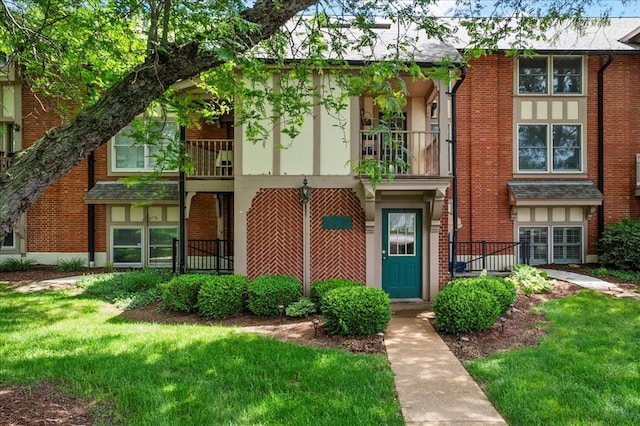 537 Colebrook Dr Unit C, Webster Groves, MO 63119 - view of front facade with a balcony, brick siding, and a front yard