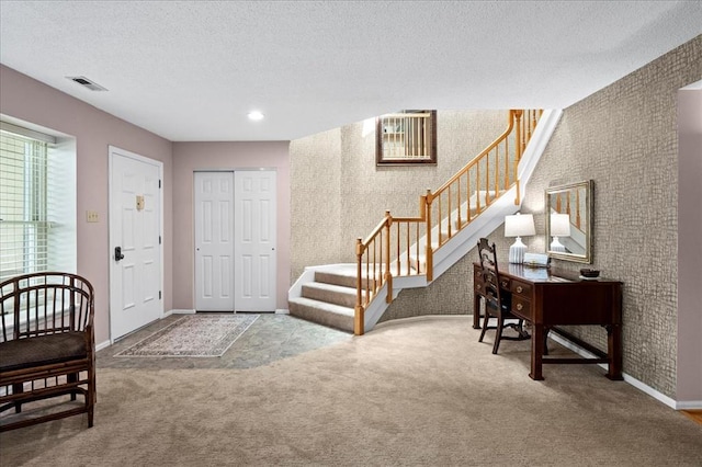 537 Colebrook Dr Unit C, Webster Groves, MO 63119 - foyer entrance with stairway, carpet floors, baseboards, wallpapered walls, and a textured ceiling
