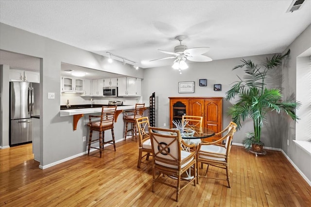 537 Colebrook Dr Unit C, Webster Groves, MO 63119 - dining area featuring track lighting, ceiling fan, light wood-style floors, and baseboards