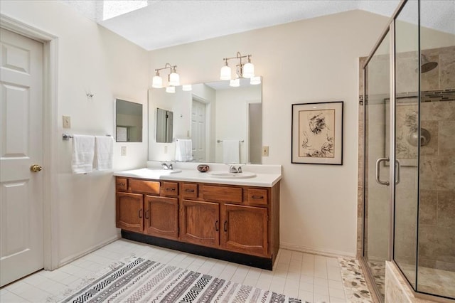 537 Colebrook Dr Unit C, Webster Groves, MO 63119 - bathroom with double vanity, tile patterned flooring, a stall shower, and a skylight
