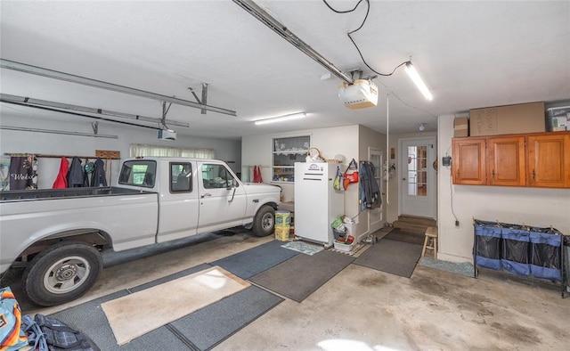 17130 State Route F, St James, MO 65559 - garage with freestanding refrigerator and a garage door opener