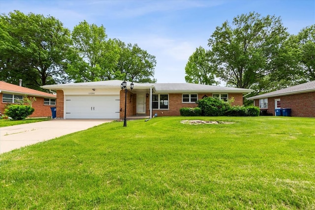 11550 Rock Hampton Dr, Hazelwood, MO 63138 - single story home featuring a garage, driveway, a front lawn, and brick siding