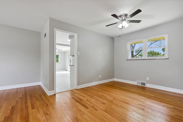 11550 Rock Hampton Dr, Hazelwood, MO 63138 - unfurnished room featuring ceiling fan, healthy amount of natural light, light wood finished floors, and baseboards
