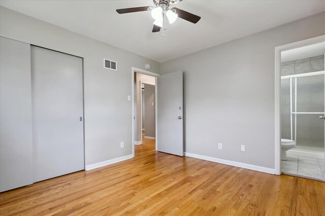 11550 Rock Hampton Dr, Hazelwood, MO 63138 - unfurnished bedroom featuring light wood finished floors, ensuite bathroom, baseboards, a closet, and a ceiling fan