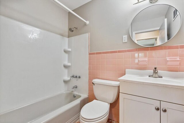 11550 Rock Hampton Dr, Hazelwood, MO 63138 - full bathroom featuring bathing tub / shower combination, tile walls, toilet, and vanity