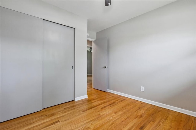11550 Rock Hampton Dr, Hazelwood, MO 63138 - unfurnished bedroom featuring light wood-type flooring, baseboards, a closet, and a ceiling fan