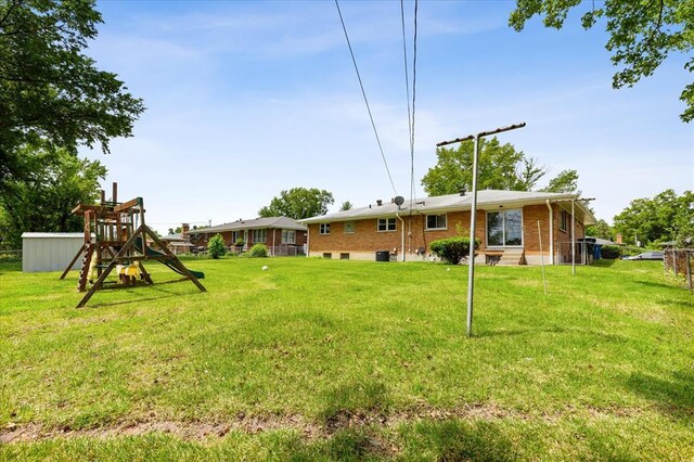 11550 Rock Hampton Dr, Hazelwood, MO 63138 - view of grassy yard with a playground and entry steps