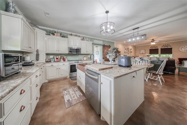 14901 State Route Ff, Edgar Springs, MO 65462 - kitchen with stainless steel appliances, concrete flooring, a ceiling fan, pendant lighting, and white cabinetry