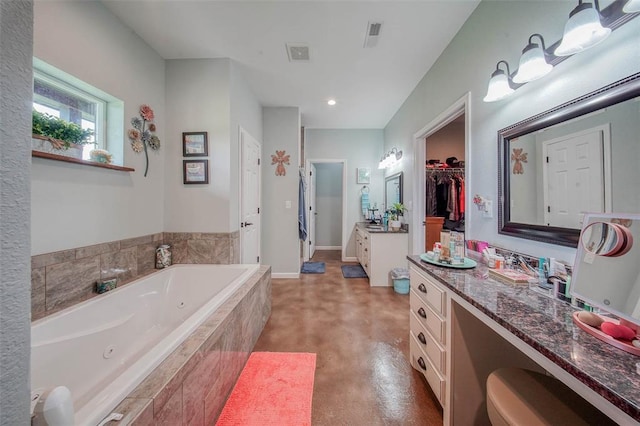 14901 State Route Ff, Edgar Springs, MO 65462 - bathroom with concrete floors, a jetted tub, vanity, recessed lighting, and a walk in closet