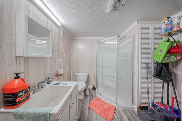 14901 State Route Ff, Edgar Springs, MO 65462 - full bath featuring wood finished floors, vanity, a textured ceiling, toilet, and a stall shower