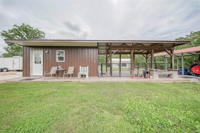 14901 State Route Ff, Edgar Springs, MO 65462 - back of property with board and batten siding, a lawn, and metal roof