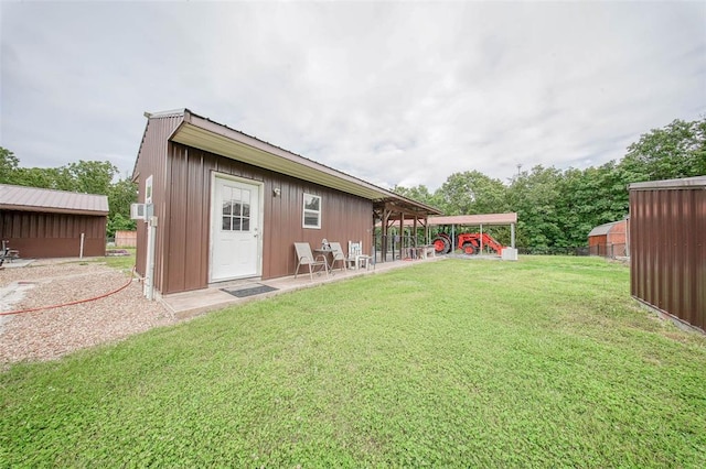14901 State Route Ff, Edgar Springs, MO 65462 - rear view of property featuring a lawn, an outdoor structure, and board and batten siding