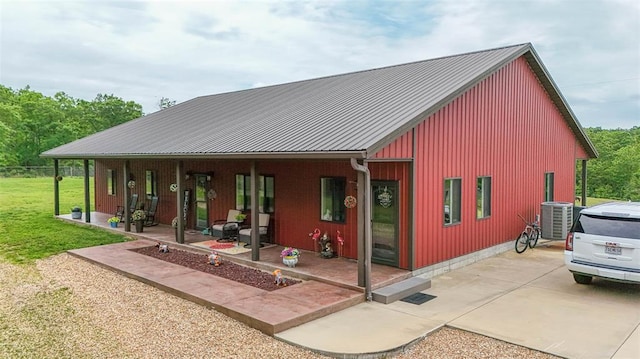 14901 State Route Ff, Edgar Springs, MO 65462 - rear view of house featuring central AC unit, covered porch, a lawn, and metal roof