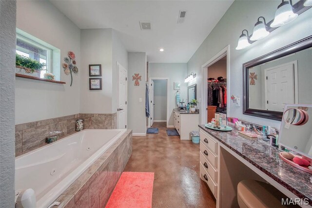 14901 State Route Ff, Edgar Springs, MO 65462 - full bathroom featuring finished concrete floors, a jetted tub, vanity, recessed lighting, and a walk in closet