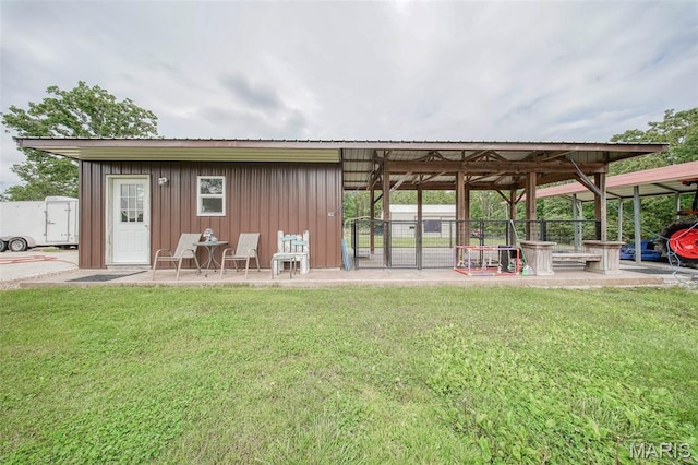 14901 State Route Ff, Edgar Springs, MO 65462 - back of house with a lawn, board and batten siding, and a metal roof
