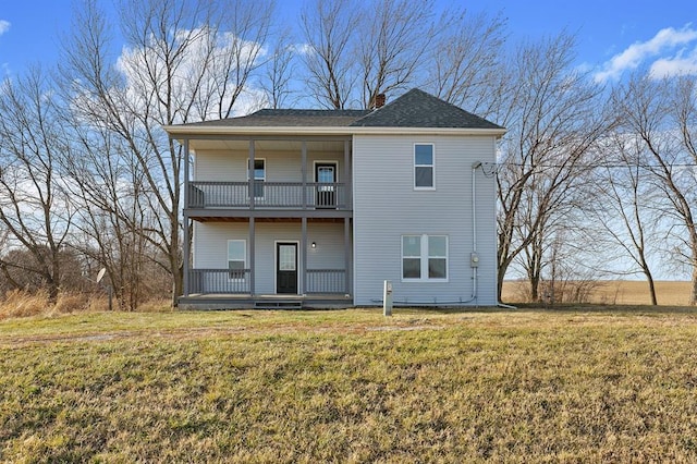 7097 State Route 3, Evansville, IL 62242 - back of property featuring a balcony, a lawn, and a chimney