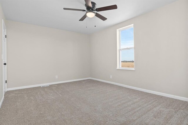 7097 State Route 3, Evansville, IL 62242 - spare room featuring baseboards, ceiling fan, and carpet flooring