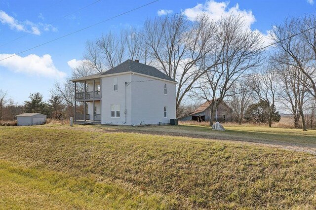 7097 State Route 3, Evansville, IL 62242 - view of home's exterior featuring a balcony, a lawn, and a chimney
