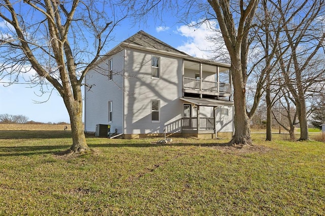 7097 State Route 3, Evansville, IL 62242 - rear view of property featuring a balcony, a yard, and central AC unit