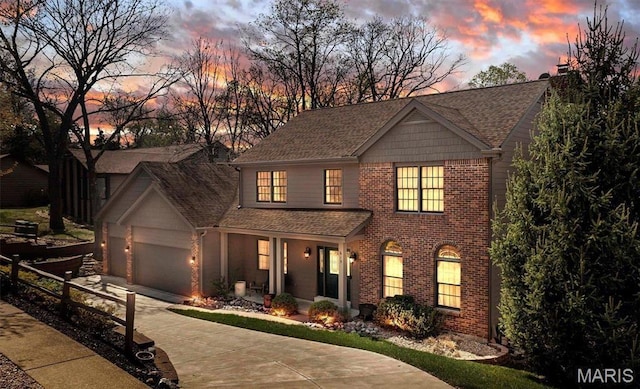615 Shadowridge Dr, undefined, MO 63011 - view of front facade featuring covered porch, brick siding, driveway, and a garage
