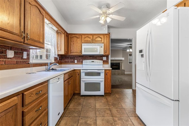 114 Fairlane Dr, Ironton, MO 63650 - kitchen featuring white appliances, a ceiling fan, brown cabinets, and decorative backsplash